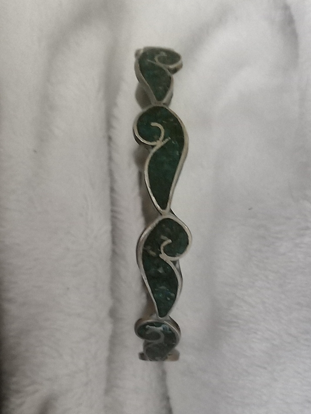 The green material is crushed malachite or turquoise chip inlay. Modernist hinge